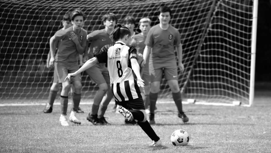 Photograph of a footballer taking a free kick